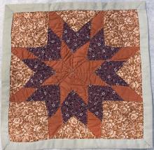 Square quilt pattern with an eight-point star.